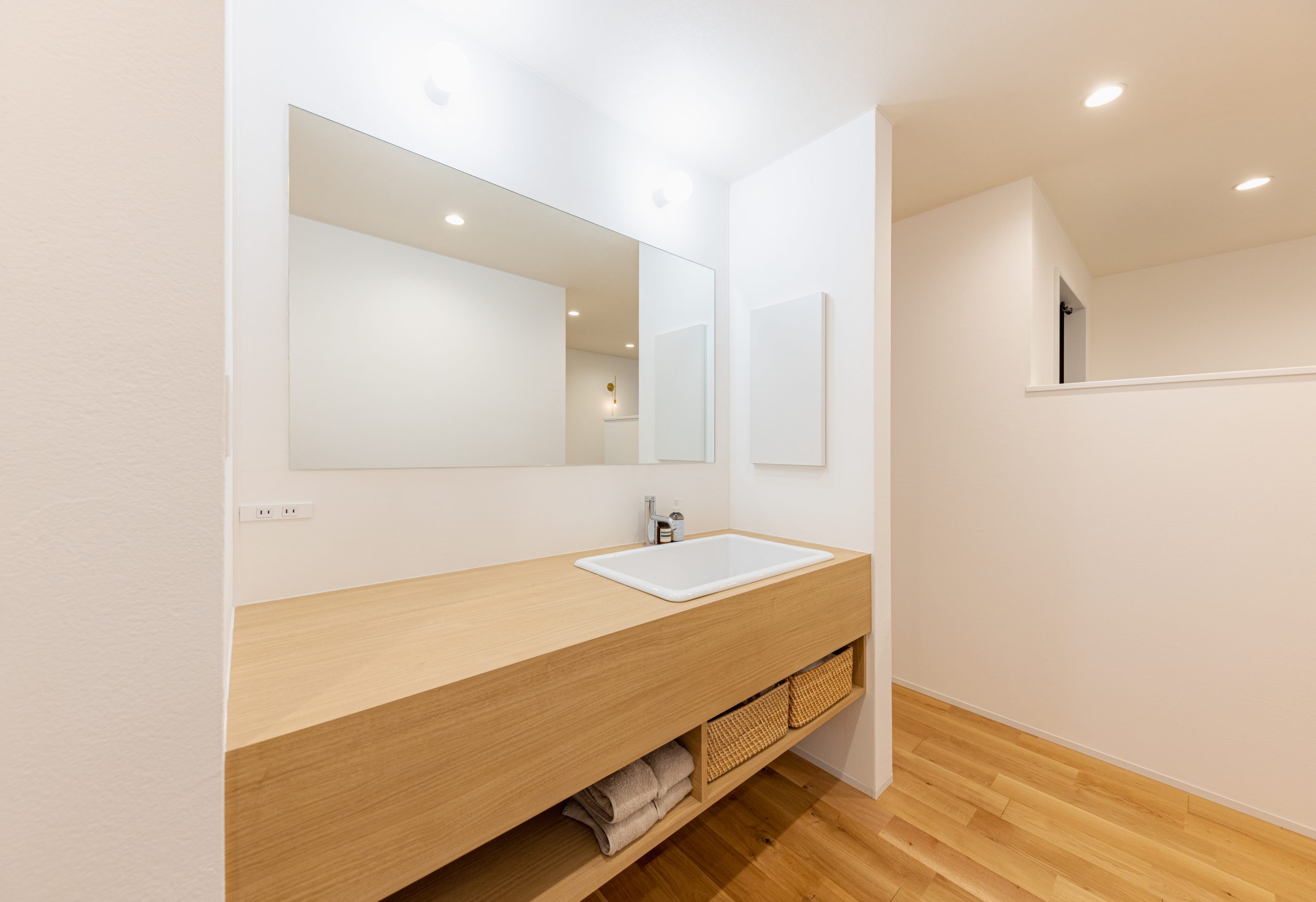 毎日を心地よく整える、木目調カウンターの洗面スペース
